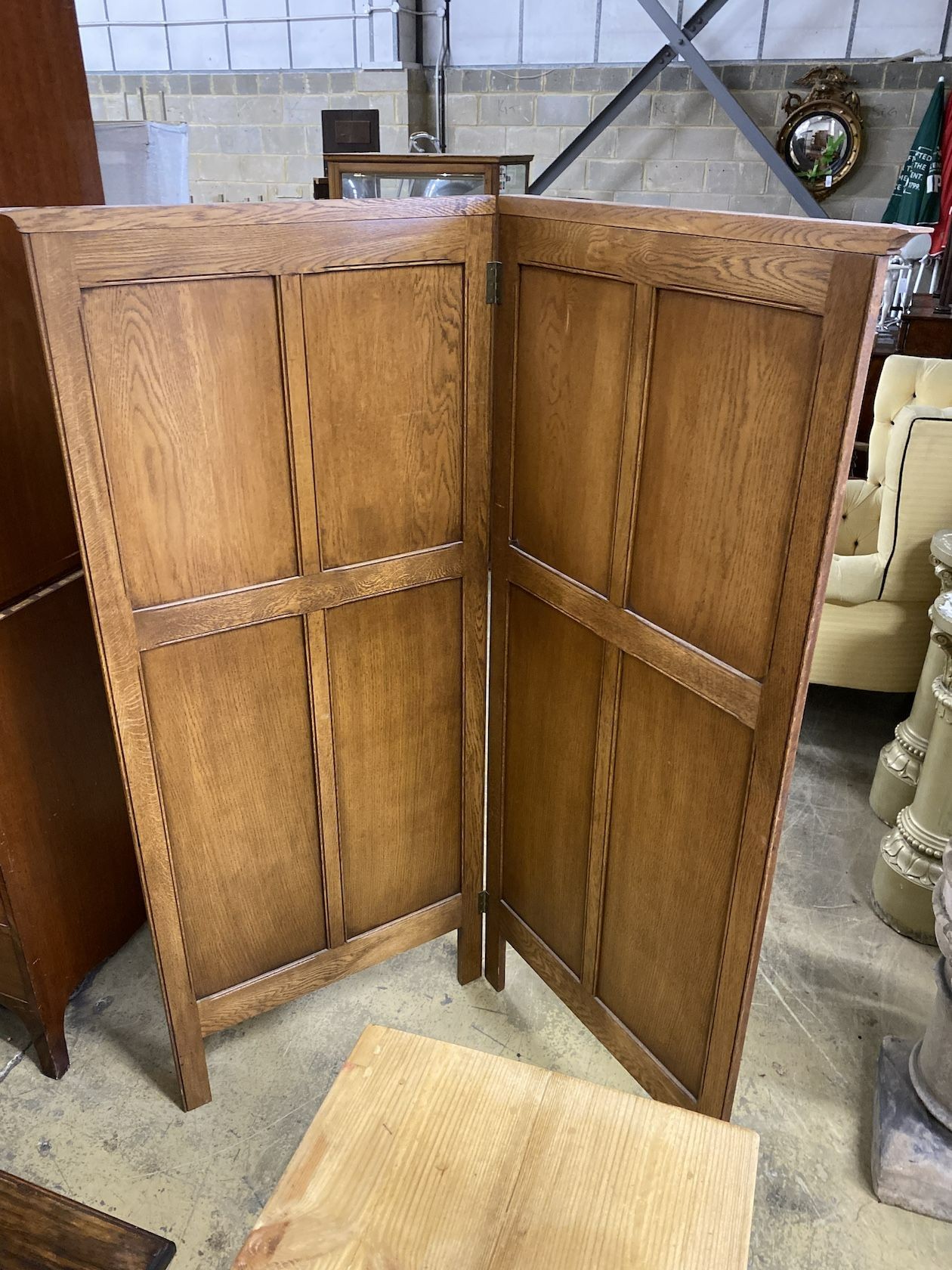 A linenfold moulded oak two fold dressing screen, each panel width 73cm, height 170cm